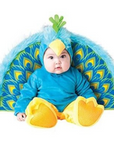 A baby wearing a blue and yellow peacock costume, sitting in front of a matching blue and yellow peacock backdrop against a white background.