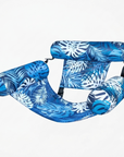 Blue tropical leaf print inflatable pool hammock with breathable mesh and two supportive PVC pillows.