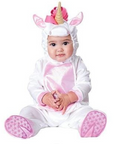 A baby wearing a white and pink unicorn costume with a horn and ears, sitting against a plain white background.