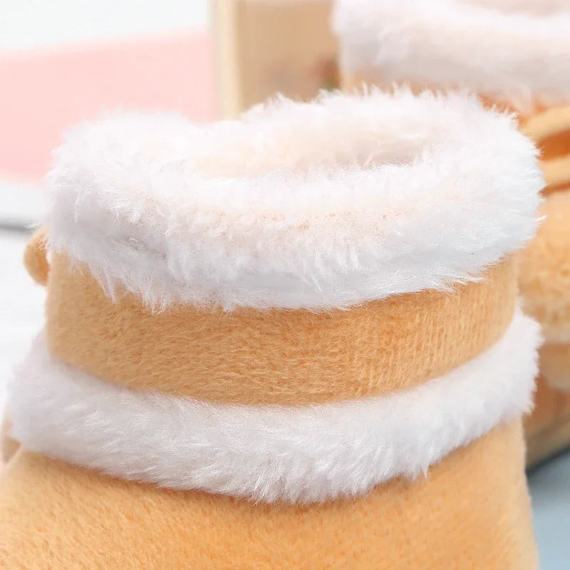 Close-up of a plush toy with white fur trim on a pink background