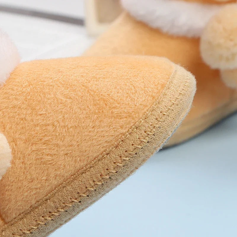 Close-up of a tan slipper with a soft texture on a light blue background